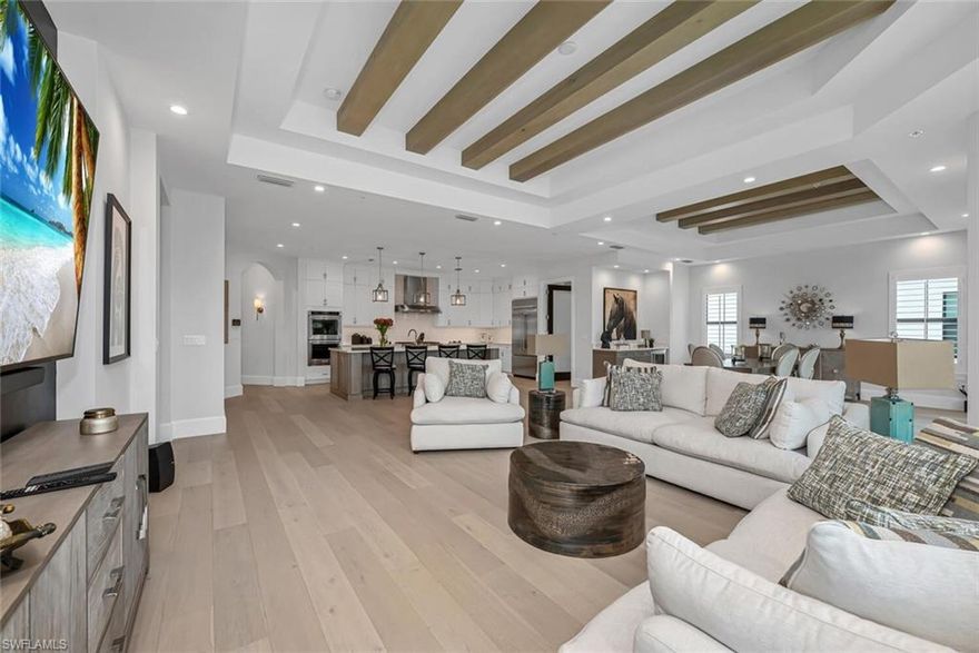 C6491  GOLF MEMBERSHIP AVAIL IMMEDIATELY! AVAILABLE FOR IMMEDIATE OCCUPANCY. Quintessential Naples living, this coach home in Talis Park welcomes you-4,402 of luxurious living. This intelligent home offers true open concept living highlighted by expansive spaces that feature stunning European white oak flooring, wood beams, and a custom wood barrel ceiling. The gourmet kitchen, generous in size, showcases chef-quality appliances and an abundance of custom cabinetry plus an epic pantry complete with built-ins! An entertaining-sized dining room with a built-in butlers area and wine refrigerator will host all your special meals! The serene owner's retreat boasts a spa-quality bath with dual sinks and showerheads, a soaking tub plus a beautifully outfitted custom closet. Two additional, well-sized ensuite bedrooms, private study, and thoughtfully designed laundry room round out this versatile floorplan. The private lanai offers an abundance of outdoor living space that includes an outdoor kitchen with an oversized Lynx grill, sink, and beverage refrigerator. This meticulously maintained home is offered with new, masterfully chosen furniture and accessories. With an immediately available golf membership plus the world-class amenities Talis Park is known for.