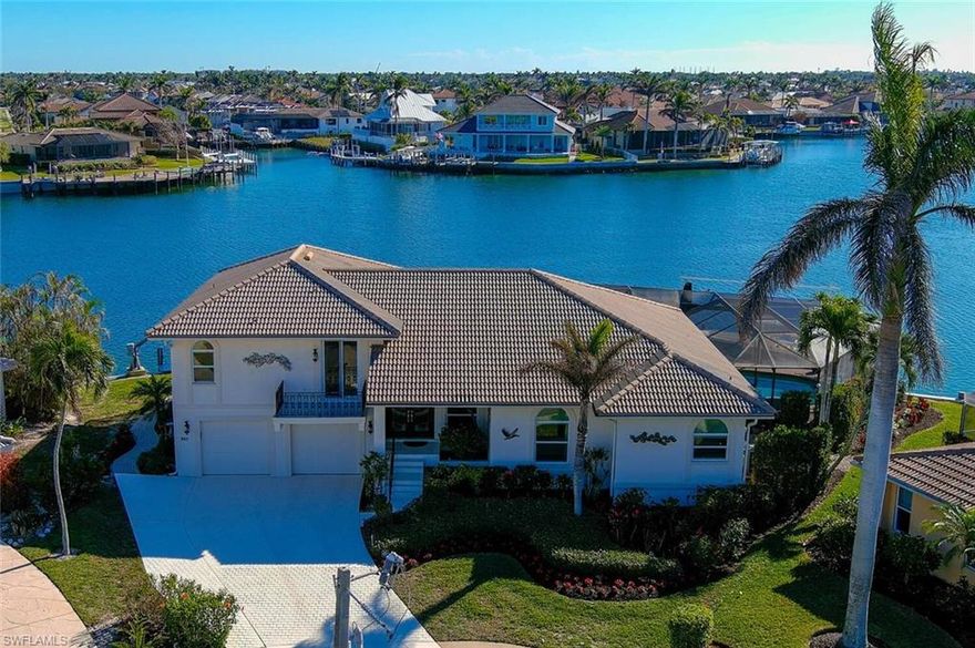 Rarely available home with expansive southern views over the Landmark waterway. The view is 180 degrees, wide and long, from this tip lot with 169 ft of waterfront. The home is ideally positioned on the lot to take in the views from the huge wrap around screened pool area, living areas and main bedrooms. The floor plan flows from the spacious great room to the outdoor living area making it perfect for entertaining. Take your choice of a primary bedroom either on the upper or lower level. 159 ft. dock with 2 lifts (6000 lb. & 30,000 lb.). Super close beach access (.3 mile) and only (.7 mile to Residents Beach. Desirable south access through Smokehouse Creek to Caxambas pass and the 10,000 Islands of the Everglades with miles of remote beaches to explore and world class fishing. See attached list of recent replacements including impact glass. Den is presently used as a bedroom.