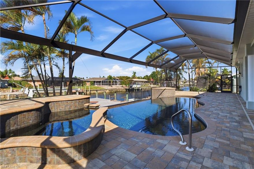 "SALT-LIFE" BOATING-FISHING-BEACHES & SUNSHINE! STUNNING $1,000,000 VIEWS & COMPLETELY REMODELED ($300,000+/-) 3 BEDROOM, DEN, 3 BATH, POOL-SPA FAMILY HOME WITH "DIRECT GULF ACCESS" AND HUGE CURB APPEAL. Huge OPEN FLOOR PLAN, 16' VOLUME COFFER-ED CEILINGS FINISHED WITH crown molding and recessed lighting. ALL TILE FLOORS in entry, halls, bathrooms and kitchen FOR EASY MAINTENANCE "CHEFS" kitchen with all wood cabinetry, steel appliances, level 5 Granite Tops, tile back-splash and CUSTOM FINISHED 2 LEVEL EAT-AT-BAR AND FAMILY GATHERING AREA WITH 6 STOOL SEATING AND A SEPARATE "BREAKFAST AL-CO" CORNER WITH MITERED GLASS OVERLOOKING THE BEAUTIFUL WATERWAY.  Master bedroom has volume ceilings, wood flooring, his & hers walk-in closets, dual granite vanities & sinks, soaking tub and glass & tile walk-in shower. Guest rooms have "wood plank" vinyl tile floors. Home has lots of glass windows and sliders, makes the home LIGHT-BRIGHT-SUNNY, all year round. POOL AREA HAS A "SOUTH BEACH" VIBE, with paver decking and custom "VANISHING EDGE"HEATED  POOL & SPA WITH "PICTURE GLASS" SCREEN CAGE, WATER FEATURE  FOR INCREDIBLE WATER VIEWS AND EVENING SUNSETS.  Fantastic "SUMMER KITCHEN" for family & guest entertaining.  FOR THE BOATER: CAPTAINS DOCK & "TREX" maintenance free DECKING WITH 10,000LB LIFT.  HOME HAS ELECTRIC "STORM SHUTTERS" ON BACK LANAI AND SMALLER WINDOWS.   Here are some of the many additional benefits and upgrades seller has done new outside lighting fixtures, LECE GenerLink Transfer Switch & Generator, Phantom retractable magnetic screen on front entry and MANOBLOC PLUMBING SYSTEM for water control. So, many upgrades, there is a list attached to this listing. The garage has tons of built-in storage space above & a pull down stairway to the attic. The driveway is also oversize, so plenty of on-site parking for entertaining. The PALACO GRANDE neighborhood has always been ONE OF THE CAPES PREFERRED LIVING AREAS, & the homes all show pride of ownership. HOME IS IN THE CENTER OF THE CITY, CLOSE TO A-RATED SCHOOLS, ALL MAJOR SHOPPING, CHURCHES, HOSPITALS, RESTAURANTS AND THE BEST OF ALL SOUTH FLORIDA ENTERTAINMENT. HOMES COMES WITH ONE YEAR "HOME WARRANTY" FOR TOTAL BUYER COMFORT!