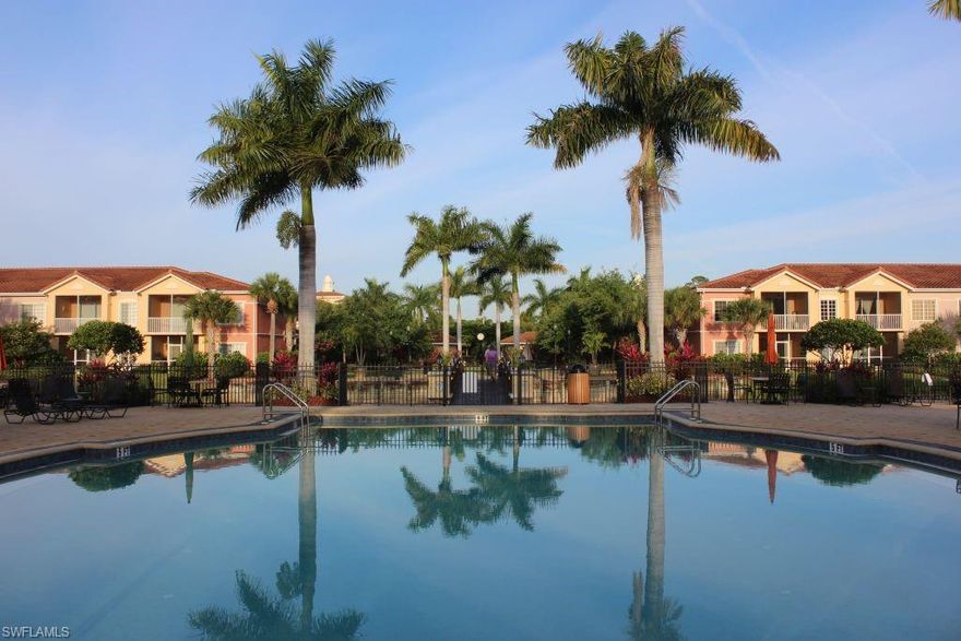 This beautiful, spacious second floor unit boasts 4 bedrooms and 2 full baths plus one car attached garage! Situated in a very desirable location within the community, walking distance to the Town Center and backs to a pond with water feature plus very quiet, lush and tropical! The PORTOFINO floorplan is the largest size home built in the community. Den was converted into the 4th bedroom!  Generous size screened lanai overlooking a tropical view of the lake and fountain!  Nicely appointed throughout featuring an open, bright floorplan with volume ceilings and crown moulding!  Granite counter tops throughout!  All appliances included plus NEW HVAC!  Easy access to Florida Gulf Coast University, SW Florida International Airport, Malls, Restaurants, I-75, US 41, and beaches! Walk to the VILLAGIO TOWN CENTER which features these amazing amenities: Movie Theater, Fitness Center, Full Menu Café, On-site Property Management Office, Royal Scoop Ice Cream Bar, man gated 24 hours a day and offers multiple swimming pools, tennis and more! LOW HOA FEES 360/mo include water, basic cable, building insurance, exterior pest control, all landscaping and maintenance plus all amenities! Don't wait!