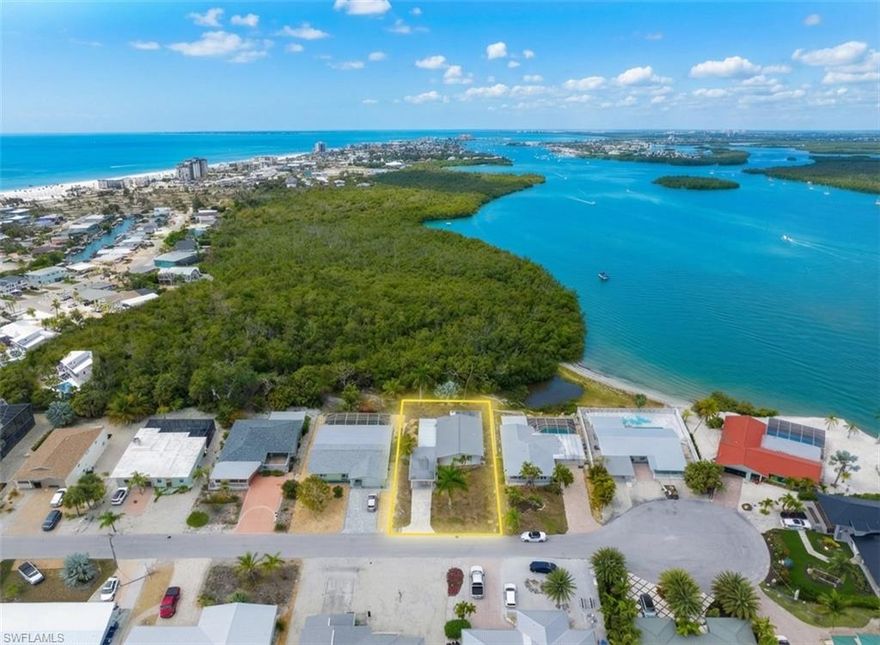 Prime investment opportunity in Fort Myers Beach. Situated on a .18-acre lot with bay views and just a short walk to the beach, this property offers strong redevelopment and income potential in a high-demand market. This lot looks over 45 acres of vacant land & Fort Myers Beach Bay, offering ultimate privacy! The existing 2-bedroom, 1-bath home features an open living area, two patio spaces, and a carport - providing the option to renovate. Whether repositioned as a seasonal rental, short-term vacation property, or new construction project, this location supports strong demand from both vacationers and second-home buyers. Opportunities to secure a bay-view lot within walking distance to the beach are increasingly limited - making this a strategic acquisition for investors focused on appreciation and income potential. Don't miss this opportunity, schedule your tour today!
