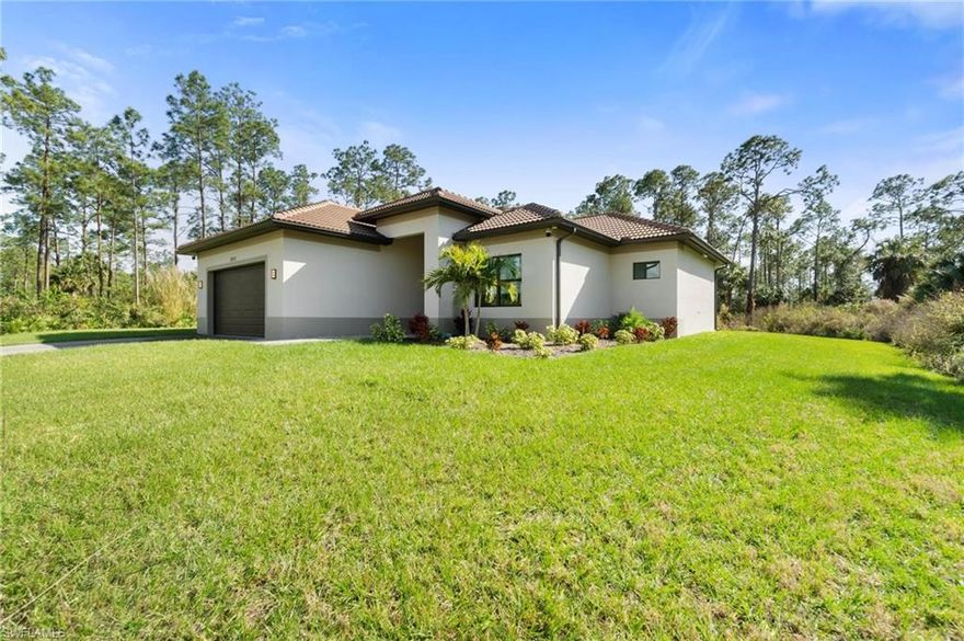 WOW! This modern luxury 3 Bedroom 2 Bathroom home in Naples, FL was completed in 2022 on a 2.27 Acre 100% Uplands lot on a quiet street in Golden Gate Estates. With an open floor plan, 10-foot-high ceilings, marble floors, 8-foot-tall doors, and high baseboards throughout the entire home, no detail was spared. The gourmet kitchen is complete with Granite Counters, Stainless Steel Appliances including double oven, oversized island and white shaker, soft-close cabinets. Also equipped with an automated sprinkler system on the grass and landscaped areas and plenty of natural wooded areas offer endless possibilities. The list of upgrades also includes Impact Resistant Windows & Doors, Custom Built in Walk-In Closet, a 500-gallon whole-home Reverse Osmosis water filtration system, built in Bluetooth Ceiling Speakers, High-End Indoor / Outdoor Surveillance Camera System, Custom Lighted Mirrors and floating bathroom vanities in both bathrooms, and epoxy floors in the 2-Car garage.  The oversized screened lanai and in-ground HEATED POOL create your own private paradise! Conveniently located close to Golden Gate Blvd. and 1.5 MILES from the brand-new Everglades Square Shopping Center!