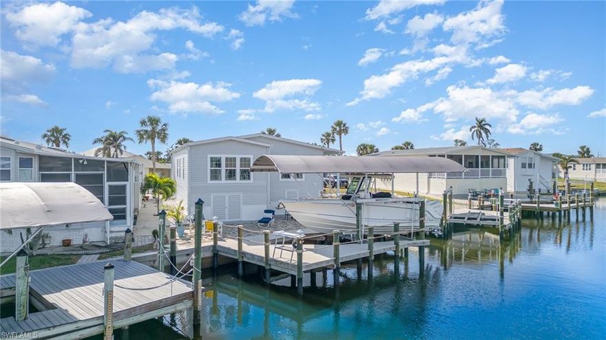 Can you believe it? You can own a stunning home in the desirable Bayside Estates for under $500K, and everything was done in 2021—everything! From the gorgeous 2021-built home to the 2021 seawall, dock with a 13K lift, and lofted garage, this property is packed with high-end updates. Inside, you'll find exquisite crown molding throughout, central air for ultimate comfort, and tons of storage space to keep everything organized. Both bedrooms are spacious enough to accommodate king-size beds, ensuring ample room to relax and unwind. Located on the saltwater side with an impressive 11ft elevation, you’ll enjoy breathtaking views and privacy. The gorgeous sunroom is perfect for relaxing, while the expansive outdoor patio is ideal for entertaining or watching dolphins and manatees. Plus, you're only 15 minutes to the island by boat, or take a leisurely ride on your bike to enjoy the beach and the new restaurants, including the popular Margaritaville. With everything completed for you, just move in and start enjoying the coastal lifestyle at its finest. Don't miss this rare opportunity!
