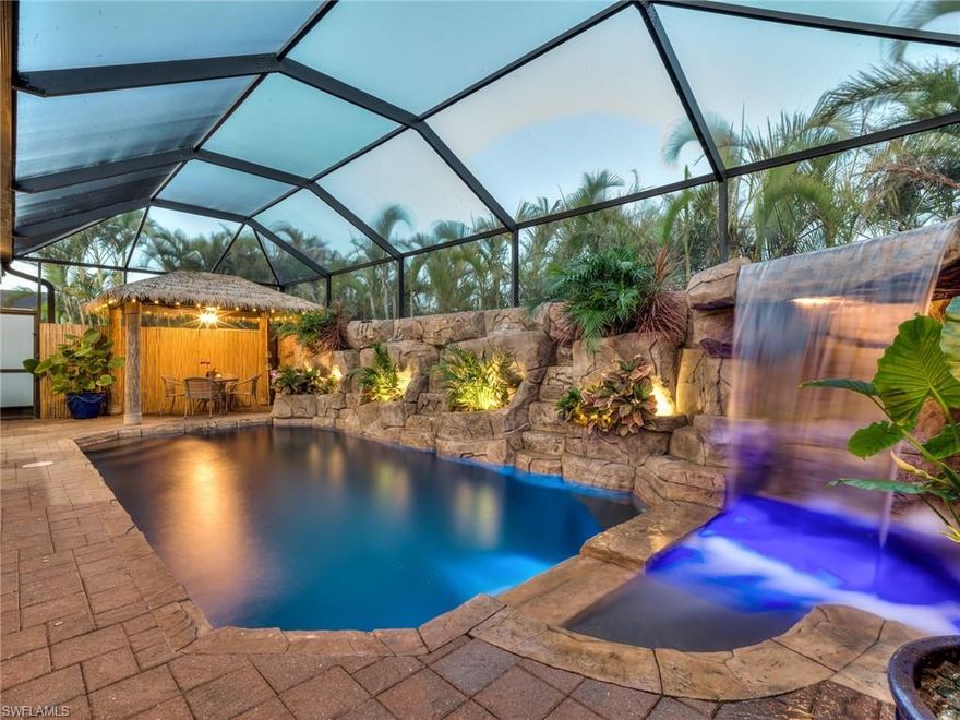 Welcome to your own tropical oasis!
This stunning Southwest Florida property is loaded with upgrades that make everyday living feel like a vacation. The backyard steals the show with a custom tropical pool, featuring breathtaking waterfalls that cascade over natural rock formations, creating a peaceful, resort-style retreat. Lounge in the sun, take a refreshing swim in crystal-clear water, and enjoy the lush landscaping and swaying palm trees that surround you—beautifully showcased by professional landscape lighting for magical nighttime ambiance. A newer pool heater allows for year-round enjoyment.
When it’s time to relax in the shade, retreat to the charming tiki hut, ideal for entertaining or unwinding with your favorite beverage. Surrounded by vibrant tropical greenery, it offers a truly private escape. The fully equipped outdoor kitchen makes dining effortless and elevates the ultimate Florida lifestyle.
Inside, the home feels refined and inviting with top-of-the-line luxury carpets, adding warmth, comfort, and an upscale finish throughout the living spaces.
This exceptional home also boasts an impressive list of upgrades, including a 24k whole-home generator with a 1,000-gallon tank, a new estate entrance gate for enhanced privacy and security, custom blinds throughout, whole-house water filtration and reverse osmosis, a newer A/C system, and fresh interior paint for a clean, modern feel.
Don’t miss this rare opportunity to own your own slice of paradise in beautiful Southwest Florida!