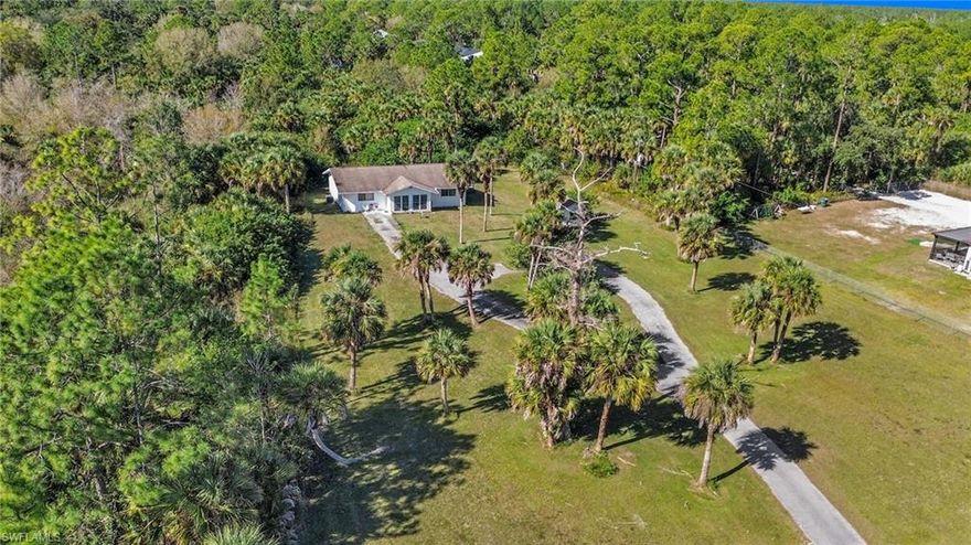 Unique opportunity to own a single-family home situated on over 5 acres in Golden Gate Estates, offering exceptional privacy and a true rural lifestyle. This expansive parcel provides endless possibilities for future use, expansion, or agricultural purposes.  With abundant space and natural surroundings, the land is ideal for those seeking room for additional structures, gardens, animals, or simply enjoying wide-open space and tranquility. The property offers a peaceful, secluded setting away from the hustle and bustle, making it perfect for buyers who value land, freedom, and long-term potential.  Whether for personal use or investment, this property stands out for its acreage, flexibility, and natural beauty in one of Naples’ most sought-after rural communities.