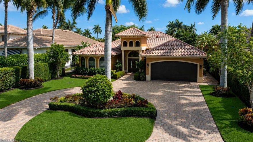 This exceptional single story Moorings residence offers a seamless blend of comfort, style, and elevated outdoor living within walking distance to the beach.
Built in 2012, this four bedroom, three and a half bath home enjoys desirable southern rear exposure and a thoughtfully designed open layout with a split bedroom floor plan, high ceilings, and abundant natural light.

Upon entry, the foyer opens to a spacious main living area highlighted by a triple tray ceiling and expansive sliding glass doors that transition effortlessly to the outdoor living space. The kitchen is both refined and functional, featuring rich wood cabinetry, granite countertops, tile flooring, premium KitchenAid appliances, and a pot filler that adds a subtle chef inspired touch. Adjacent to the kitchen, the dining area is enhanced by custom built ins and a well appointed wet bar, creating an ideal setting for entertaining.

The primary suite serves as a private retreat, complete with a separate sitting area and an elegant ensuite bath featuring dual vanities, a soaking tub, a walk in shower, and a separate water closet with bidet. Three additional guest bedrooms are generously sized and thoughtfully detailed, including one with built in shelving for added flexibility.

Outdoor living is where this home truly shines. The fully screened lanai features a heated pool with sunshelf and spa, an outdoor shower, and a dedicated pool bath for added convenience. The outdoor kitchen is designed for entertaining, complete with a built in Weber grill, brick pizza oven, refrigerator, ice maker, sink and granite countertops. A charming outdoor fireplace completes the space, creating a comfortable setting for both daytime relaxation and evening gatherings.

Additional features include crown molding throughout, plantation shutters, tile flooring, and a spacious two car garage complemented by a circular driveway providing ample parking. Ideally located just minutes from Fifth Avenue South, this property is eligible for private Moorings Beach Park access and delivers a refined indoor/outdoor lifestyle within walking distance to the beach in one of Naples’ most sought after locations.