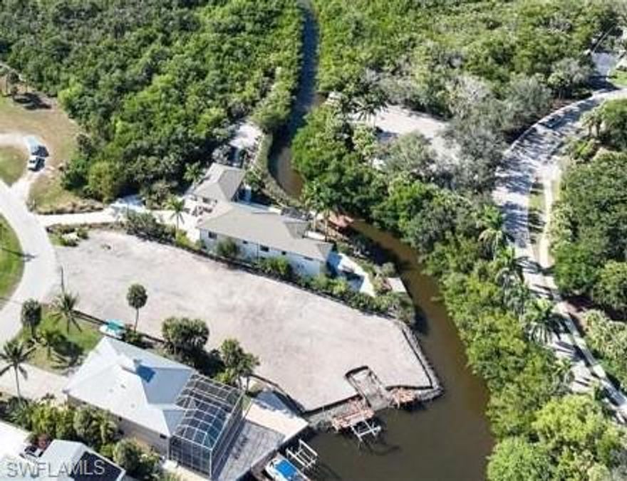 WOW - Size does matter.  + - 138 feet of shoreline, Brand New Private Boat Ramp, Brand New Boat Dock, Brand New Rip Rap, and yes, close to half of an acre with Gulf of America access through Estero Bay.  Lot is cleared, with water meter and temporary power at site.  This is a once in a generation opportunity.  A property combining this size, a brand new private boat ramp and dock with Gulf access.  Property is almost at end of a very quiet street and basically no direct neighbors accross the rear of property, see pictures. We have a two story 5 bedrooms, 5 baths, plus office house plans already drawn up if buyer wants to use it or revise it with their builder.  All the hard work has been done for your.  Soil Test does not require piling for current house plans, DEP approved for dock and rip rap ... Just dream and build it ... be close to nature at its best.