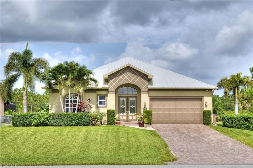 Have you been looking for a custom home that is REALLY move in ready? This is it! Located in the Buckingham Park community with no hoa fees, it is located on the only street that backs up to the Lee County 20/20 nature preserve. So no direct neighbors behind you! The outside of the home has been carefully maintained with beautiful landscaping, underground drainage, plush lawn, auto sprinkler system, paver driveway, metal roof, 250 gallon underground propane tank for gas stove, grill, and tank-less water heater, and a fenced back yard. The home has 10' volume ceilings throughout, crown molding, 18 inch tile laid diagonal in living and wet areas, carpet in guest rooms, and laminate wood flooring in the master. The kitchen has custom wood 42" cabinets, granite counter tops, high end stainless appliances, gas stove, island w/sink, and a wrap-around bar. Downstairs lanai has an outdoor kitchen with sink, fridge, and gas grill vented. The upstairs media room has wood floors and its own private balcony! The master has dual walk in closets, dual sinks, a jetted tub, and a separate shower with rain style shower head as well as a jet system. Too much to list! Call today!