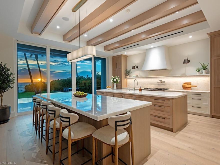 This Gulf-front masterpiece offers an unparalleled blend of location, luxury, and resort-style living. The home has experienced no water intrusion in living areas during recent weather events. The residence combines historic charm with sophisticated elegance. The home underwent an extensive three-year renovation and reconstruction, completed in 2024 with Kukk Architecture. Now practically new, the residence preserves its heritage, grandfathered footprint, and distinctive character while offering modern luxury throughout. The 6,100-square-foot, fully air-conditioned living space maximizes its premier beachfront setting. The well-designed layout offers five spacious bedrooms, five full and two half baths, a private study, and a flexible sixth bedroom. Sweeping Gulf views provide a stunning backdrop. The gourmet kitchen boasts dual Cristallo quartzite islands, top-tier appliances, custom cabinetry, and a service kitchen. Additional features include a private gated entry, two fireplaces, elevator, whole-house generator, automated screens/shutters, water filtration, and ultra-efficient air conditioning. Perfectly positioned on the Gulf, just moments from the dining and boutique shopping of Third Street South and Fifth Avenue South. A rare opportunity in the heart of Old Naples.