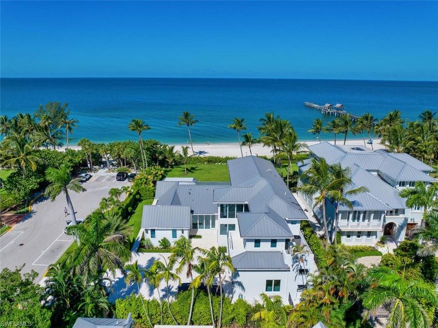 This Gulf-front masterpiece offers an unparalleled blend of location, luxury, and resort-style living. Elevated above FEMA height standards, the home has experienced no water intrusion in living areas during recent weather events. The residence combines historic charm with sophisticated elegance. Originally built in 1886, the home underwent an extensive three-year renovation and reconstruction, completed in 2024 with Kukk Architecture. Now practically new, the residence preserves its heritage, grandfathered footprint, and distinctive character while offering modern luxury throughout. The 6,100-square-foot, fully air-conditioned living space maximizes its premier beachfront setting. The well-designed layout offers five spacious bedrooms, five full and two half baths, a private study, and a flexible sixth bedroom. Sweeping Gulf views provide a stunning backdrop. The gourmet kitchen boasts dual Cristallo quartzite islands, top-tier appliances, custom cabinetry, and a service kitchen. Additional features include a private gated entry, two fireplaces, elevator, whole-house generator, automated screens/shutters, water filtration, and ultra-efficient air conditioning. Perfectly positioned on the Gulf, just moments from the dining and boutique shopping of Third Street South and Fifth Avenue South. A rare opportunity in the heart of Old Naples.