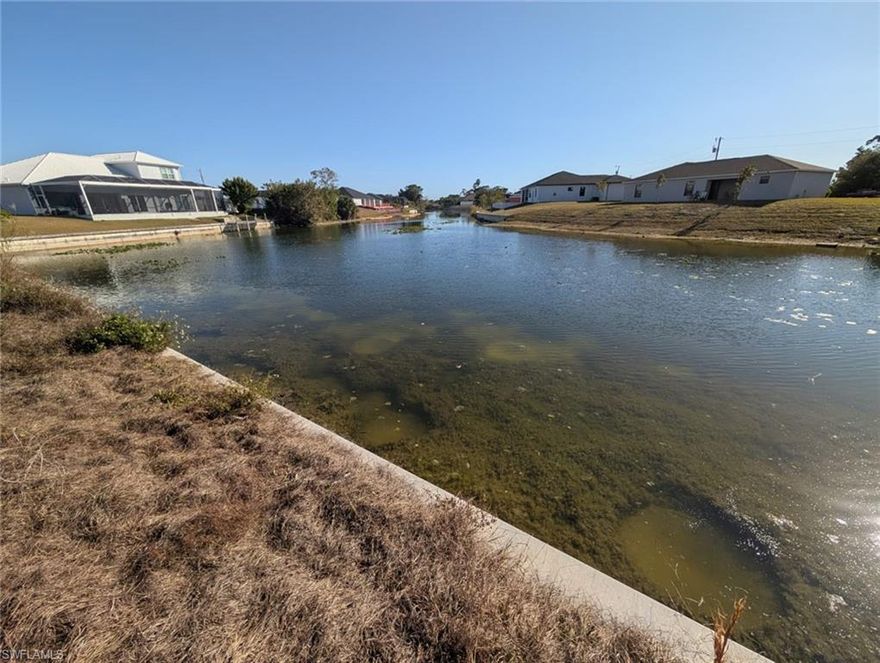 Discover the perfect location to build your dream home on this slightly oversized waterfront lot in beautiful Cape Coral. Situated on a wide canal, this property offers stunning water views down the entire canal and the highly desirable southern rear exposure, providing sunshine on your future pool and outdoor living space throughout the day. The lot features a brand-new seawall, saving you significant construction costs and giving you a head start on building. With extra space compared to standard lots, you'll have more flexibility for your home design, landscaping, and outdoor entertaining. Located in a growing area of Cape Coral, this property offers easy access to shopping, dining, schools, and all the amenities Southwest Florida has to offer. Whether you're planning to build now or invest for the future, this waterfront homesite is a fantastic opportunity. City water is already in place so no need to build a costly well! Don't miss your chance to own a piece of paradise with wide canal views, southern exposure, and a new seawall already in place. *Lot next door is also available for sale*
