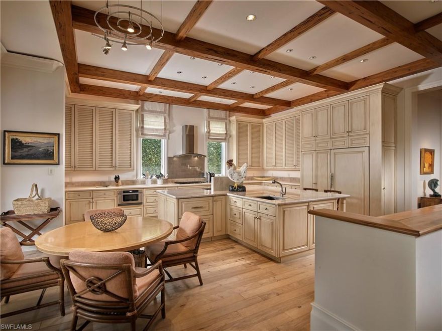 Coastal Caribbean architecture, incredible quality of construction, impressive custom woodwork and a modern floorplan all come together to enhance the spectacular long water views seen from nearly every room.  Custom designed by Stofft Cooney architects and masterfully crafted by Kurtz homes this 5 bedroom + den waterfront gem was well ahead of its time, featuring hidden linear diffusers, Nano glass doors, Crestron smart home system & Lutron lighting, screens and shutters on the lanai, outlets in the baseboards, generator and so much more.  The expansive kitchen with plentiful cabinetry and luxurious quartzite countertops opens seamlessly to the outdoor kitchen, living area and fireplace for easy entertaining.  The serene master suite offers banks of clear glass open to the bay, 2 spacious and well-designed closets and plenty of space to unwind. Ideally situated on a prime piece of property with a well-maintained boat dock and lift and just a short stroll to the Park Shore beach association this house has it all to make your Naples lifestyle picture perfect.