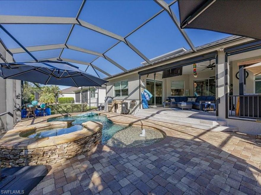 Experience the pinnacle of stress-free Florida living in this masterfully designed residence in gated Catalina Isles. This ready to move in  home blends high-end luxury with the comfort and ease of Florida living, featuring a new charcoal metal roof (2024), dual high-efficiency A/C units (2022/2024), and comprehensive storm protection including electric hurricane screens.
The chef’s kitchen is a showpiece of culinary excellence, boasting stainless steel double ovens, an oversized island with built in beverage fridge and wine cooler, and custom dual pot fillers. The first-floor primary suite offers a private, spa-like retreat with dual walk-in closets and a soaking tub. Luxury extends to the car enthusiast's dream garage, featuring 12-foot ceilings and a professional car lift offering 3-car capacity and electric vehicle charging capability .
Outside, your private oasis awaits with a heated pool and spa (new heater/pump 2023) and a built-in summer kitchen, all framed by a lush, fenced yard with reclaimed irrigation. With low HOA fees covering cable and lawn maintenance, this home is designed for ease of living and sophisticated comfort. Refinement in every detail. Serenity in every corner