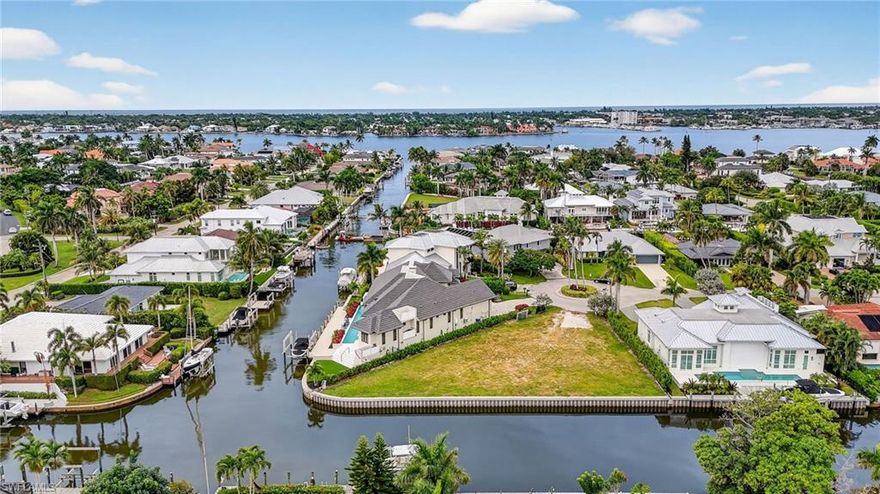 Set within the coveted boating enclave of Royal Harbor, this prime corner parcel presents an outstanding opportunity to create a custom waterfront residence in one of Naples’ most desirable coastal communities. The property has been enhanced with a newly constructed 138-foot seawall and enjoys a scenic canal setting with direct, bridge-free access to Naples Bay, making it ideal for avid boaters and those who value life on the water.

From sunrise to sunset, the setting delivers captivating water views and a tranquil backdrop for everyday living. With ample frontage and a highly functional lot orientation, the property is well suited for a thoughtfully designed luxury home that embraces indoor-outdoor living and effortless access to the bay. Whether envisioned as a signature build by a custom builder or a personalized retreat for a future owner, the location and infrastructure offer a strong foundation for a truly exceptional residence.

Just minutes from the sugar-sand beaches of the Gulf and the energy of Downtown Naples, this address blends privacy with proximity. Nearby waterfront dining, a newly introduced boutique hotel, and the charm of Old Naples further elevate the lifestyle, placing world-class dining, shopping, and entertainment within easy reach.

This is a rare chance to secure a waterfront homesite where boating convenience, coastal elegance, and a premier Naples location come together—an ideal canvas for creating a timeless waterfront escape.