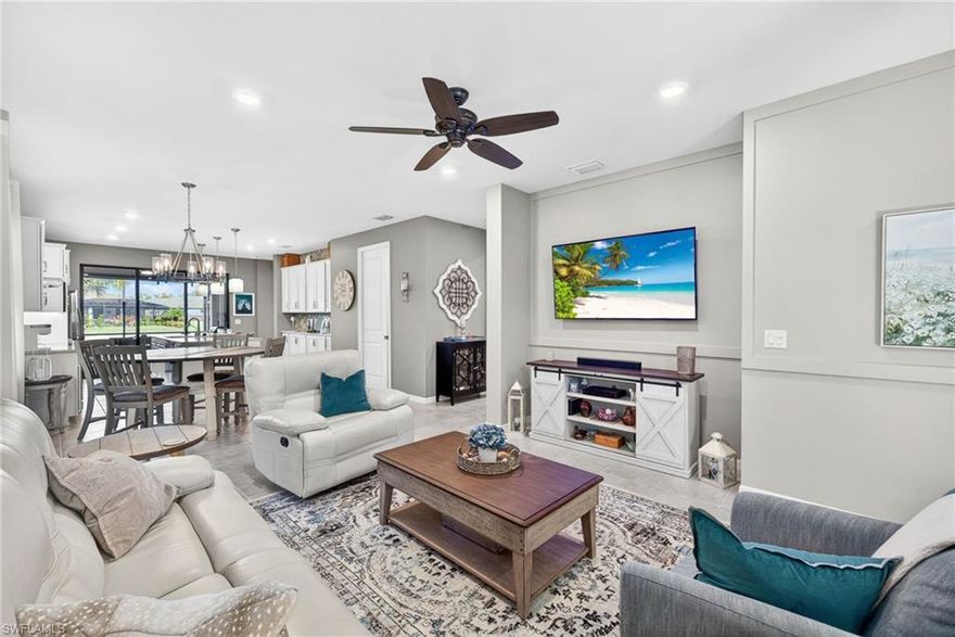 Full of charm and thoughtful upgrades, this 3 Bedroom, 2 Bathroom home stands out with its stylish finishes and attention to detail. The glass entry door offers a welcoming first impression and hints at the custom touches found throughout. Inside, the living spaces are enhanced with eye-catching wall treatments and recessed lighting that add both warmth and dimension. The kitchen delivers a unique blend of function and flair, featuring a wallpaper accent wall, quartz countertops, tile backsplash, new refrigerator, induction range, lower cabinet pull-outs, and an impressive wall of buffet cabinetry—ideal for entertaining and everyday convenience. Tile flooring in both the primary and second bedrooms adds a clean, cohesive look, while the second bedroom includes built-ins that can remain, offering added versatility. Eight-foot doors throughout elevate the overall sense of space. The laundry room is anything but ordinary, finished with beadboard detail, extra cabinetry for added storage, and a built-in beverage center. Additional highlights include a whole-house water filtration system and overhead garage storage for practical ease. Outside enjoy stunning sunsets on the extended covered lanai providing a comfortable retreat with tranquil lake views—perfect for relaxing or hosting guests. Located in Bridgetown, residents enjoy an exceptional amenity-rich lifestyle with a resort-style pool, lap pool, fitness center, tennis, pickleball, and a wide variety of organized activities and events designed to bring neighbors together. A home with distinctive character and meaningful upgrades, ready to be enjoyed from day one.  Make an appointment today to see it!