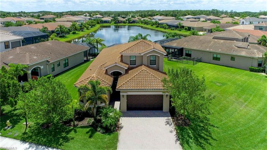 Enjoy picturesque views over the water poolside in your Bahama model from GL homes that has stunning long lake views. Screen enclosure was just installed around the heated pool and has a panorama siding. All the bedrooms are down stairs with another huge bedroom full bath upstairs. This home has many desired upgrades, from whole home water filtration, electric rolldown hurricane screening on the outside by the pool, crown molding, and quartz countertops in all the bathrooms. This floorplan was designed and created for optimal comfort when relaxing or entertaining. Nothing makes you feel at home such as your very own gourmet kitchen. Kitchen features beautiful staggered white cabinetry featuring GE profile appliances and hood over range. The owner's suite is overlooking the water and has a giant luxury bathroom you must see to appreciate! With the high ceilings, large glass sliders and tray ceilings throughout your home you will feel like you are truly living in a model home. Marina Bay is one of Southwest Florida's most desired communities close to RSW, FGCU, JetBlue sports park, a resort style pool, tennis, state of the art fitness center, and affordable HOA with so much more.