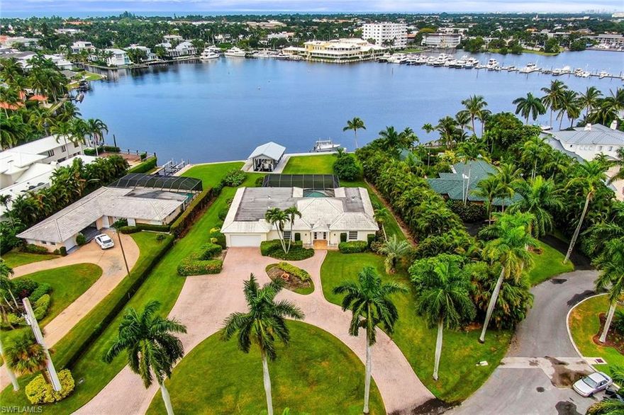 An extraordinary opportunity to purchase one of Aqualane Shores' most treasured locations. Showcasing expansive panoramic vistas of Naples Bay, this oversized parcel measuring 183 x 259 x 105 x 239 offers a northwest exposure over protected water with a new sea wall, newer boat dock with 10,000 lb lift, and a remodeled covered boat slip with 32,000 lb lift featuring cypress tongue and groove ceiling and a metal roof. Bring your design inspiration and experience this magnificent property.