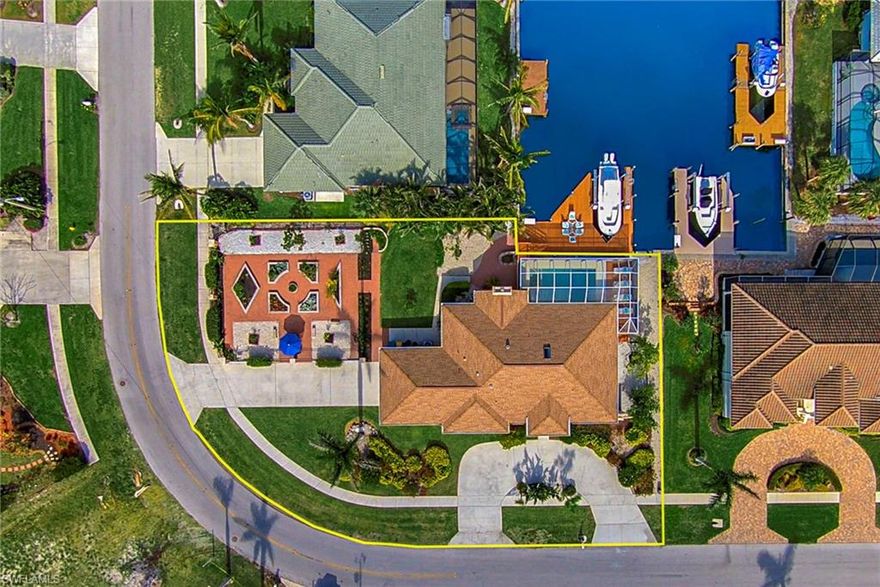 Paradise awaits you in this magnificent waterfront island home with breathtaking LONG water views. Watch dolphins and manatees swim by as you enjoy the sunset afterglows on the water right in front of your home.  This BOATER'S DREAM HOME is located on a rare-to-find LONG water view oversized lot with quick 15-minute indirect access to the Gulf of Mexico. This home boasts a generous sized deck complete with a 12,000 lb boat lift with protected straight-in docking. This bright and airy 2,300+ sq.foot home has 3-bedroom, 2-bathroom and offers a stunning floor plan that is perfect for entertaining family and friends.  Upgrades include a chef’s kitchen, volume ceilings, wood-burning fireplace, completely brand-new air conditioning (installed 2017), and gorgeous ceramic tile. Enjoy resort-style outdoor luxury on the large screened-in lanai with pool and spa overlooking fantastic canal views. This home also includes your own sanctuary garden with fruit trees, vegetables, and sumptuous flowers, which also serves a perfect place for garden parties.   Located one mile away from Residents Beach, and just a short walk to Mackle Park, the History Museum, and the public library.