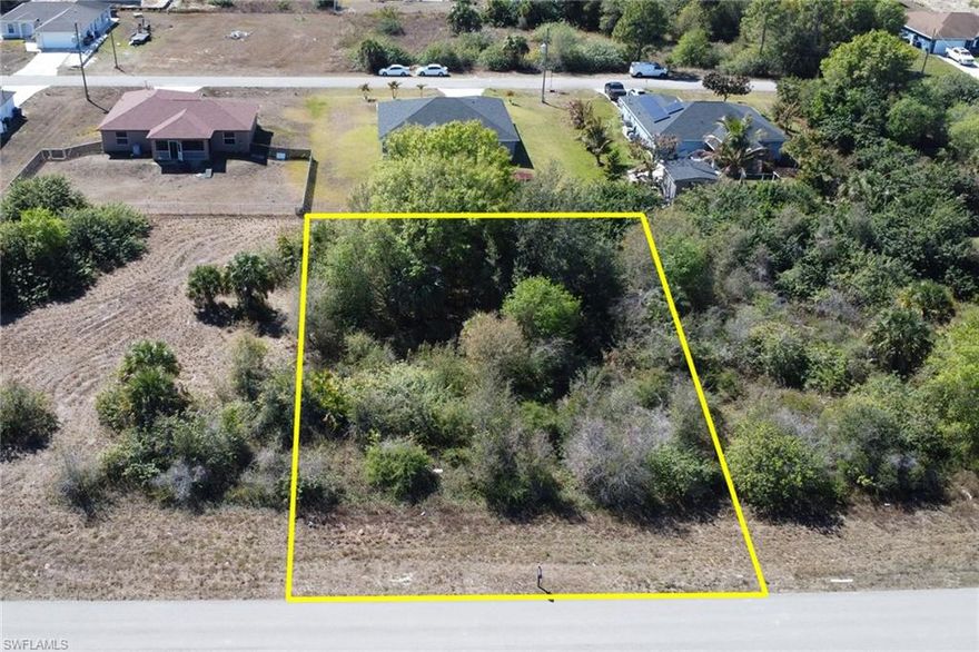 An exceptional opportunity to build your custom dream home in the heart of Lehigh Acres.
Perfectly positioned on Sunniland Blvd, this generously sized homesite is framed by mature native vegetation, offering a rare sense of privacy while still being surrounded by newer construction and established residences. The aerial views highlight a peaceful residential setting, wide road frontage, and a neighborhood that continues to grow with quality homes and long-term value.

This partially wooded lot provides the ideal canvas—preserving natural beauty while allowing flexibility for a thoughtfully designed custom residence. Enjoy the freedom of no HOA or restrictive covenants, giving you full control to create a home that reflects your lifestyle, whether that’s a modern Florida retreat, a spacious family residence, or a smart long-term investment.

Conveniently located near major roadways, schools, shopping, dining, and everyday essentials, this property balances tranquil surroundings with effortless accessibility. The surrounding aerials showcase open space, quiet streets, and a community poised for continued growth—making this an ideal opportunity for builders, investors, or future homeowners alike.

Build with vision. Live with intention. Invest with confidence—this is your chance to secure a prime piece of Lehigh Acres and bring your Florida dream to life.