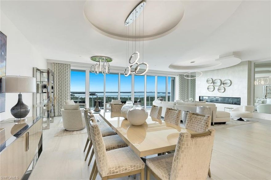 An exceptional standard of luxury living in one of Bonita Bay’s most prestigious addresses. Introducing an extraordinary, never-lived-in custom Robb & Stucky furnished model that exemplifies refined luxury living in Omega at Bonita Bay. Encompassing 4,210 square feet of impeccably curated interiors, this remarkable residence offers an unparalleled blend of sophistication, comfort, and panoramic beauty. From the moment of arrival, a sense of exclusivity unfolds as your private elevator opens to a personal foyer, setting the stage for the dramatic open-concept design beyond. Soaring 10-foot-4-inch ceilings, designer lighting, and elegant flooring frame walls of floor-to-ceiling glass that flood the home with natural light and showcase breathtaking 78-foot-wide vistas of the Gulf, bay, and golf course. The expansive living area is anchored by a sleek fireplace and seamlessly transitions into a spectacular terrace complete with an outdoor kitchen—perfect for sunset dining and elevated entertaining against sweeping western skies. At the heart of the home, the gourmet kitchen is a statement of both beauty and performance, featuring Wolf and Sub-Zero appliances, white Irpinia cabinetry, quartz countertops, and an oversized center island designed for gathering. A sophisticated glass partition subtly separates the den and office, maintaining openness while adding architectural interest and flexibility. The thoughtfully designed layout includes three luxurious bedroom suites, each offering its own captivating view, private ensuite bath, and walk-in closet. The primary retreat is a sanctuary of comfort, complemented by spa-inspired finishes, a soaking tub, an expansive walk-in shower, and dual vanities designed for indulgent daily living. A total of three and a half beautifully appointed bathrooms ensure comfort for both residents and guests. Impact-resistant glass, meticulous craftsmanship, and over $250,000 in designer upgrades elevate the residence even further. Completing this rare offering is a private three-car garage—one of only six within Omega—an exceptional feature in high-rise luxury living. Residents of Omega enjoy white-glove amenities including 24-hour staff, a resort-style pool and spa, an elegant gathering room, a state-of-the-art fitness center overlooking the golf course and lake. Residents of Bonita Bay enjoy an unmatched lifestyle with access to a private beach club, kayaking and canoeing, pickleball and tennis, multiple parks, and more than 12 miles of walking and biking paths. Golf enthusiasts will appreciate five championship courses, along with multiple dining venues, a state-of-the-art fitness center, and a full-service marina (club membership required).
Ideally located just minutes from world-class dining, shopping, beaches, and nature preserves, with easy access to Downtown Bonita Springs, Downtown Naples, and RSW International Airport, this residence offers the perfect balance of luxury, convenience, and coastal living.