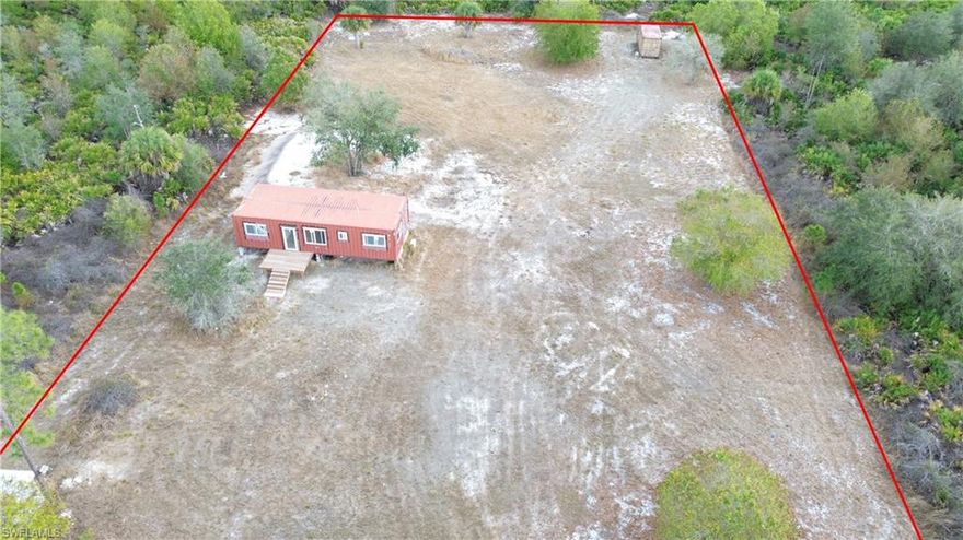 This 1.25-acre parcel is cleared, fenced in with culvert installed and is ready to be finished. Has a 692 sq ft Container home approved to be finished designed for a 1bedroom 1 bath Single Family Home. With County permission, permit can be transferred and finished and closed out, almost 90% finished. Add your personal touch.  Septic and well in place as well as electric hookup. This property is great for owner builders or someone looking for a deal. Seller will provide the plans, elevation certificate and survey. Call to schedule your private showing. Don't delay, call today!