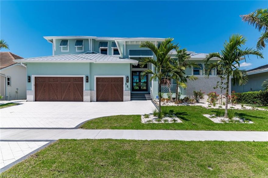 This beautiful, coastal contemporary, brand new home is full of upgrades. The custom floor plan includes 4 bedrooms, 4 bathrooms, large great room, kitchen and dining area overlooking the pool and spa, generator, and a 3-car garage with over-sized driveway. This home boasts high ceilings with custom detail, 10' sliders, impact windows, outdoor summer kitchen, and covered lanai with fireplace and a fantastic long water view. The bright, open concept design includes upgraded kitchen cabinets, quartz countertops, large island, walk-in pantry, and wood flooring throughout. This must-see home is located just minutes to the white sand beaches of Marco Island, parks, tennis and pickle ball courts, golf, shopping, dining, schools, and the YMCA.