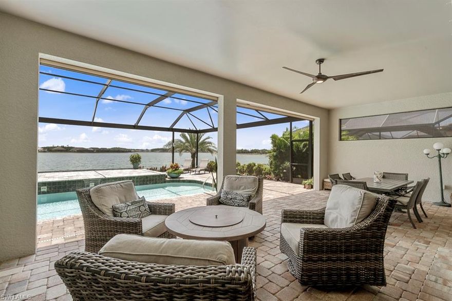 Stunning Stonewater home on a pristine lake that makes you feel that you are on your own oasis. Almost $200K of  high-end upgrades to the interior and exterior. The kitchen includes high end Jen-Aire appliances, wine fridge, granite, soft close cabinets and drawers. R/O in kitchen as well. Great Room offers Coffered Ceilings, Electric Fire Place, Custom Den Barn Door.
Large extended lanai with custom landscaping and LED lighting. Self watering planters. Retractable hurricane screens. Pool was custom built with solar heater and jacuzzi. 
Community features amazing amenities and restaurant/bar.
This home is a must see....See attached list of upgrades!