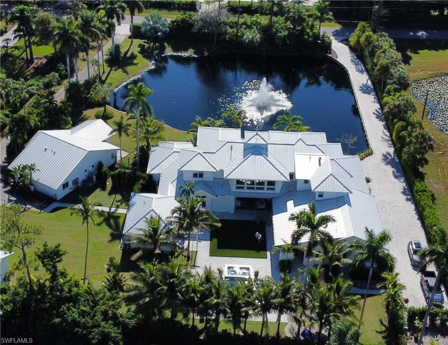 One of a kind MHK home on the best street in Pine Ridge Estates.  As you pull into the driveway you are greeted with a breathtaking ½ acre lake and dramatic fountain.  Lush landscaping surrounds the home, man cave, guest house and gym all on 1.67 acres offering total privacy.  The interior boasts an open spacious floor plan with incredible indoor/outdoor living.  The outdoor kitchen, dining, lounge area, pool/spa, gas fire pit and  gas fireplace is an entertainer's dream.  The gourmet kitchen is a chef’s dream with wolf/subzero appliances, a full butler’s pantry with wine storage.  The great room, kitchen and dining offer panoramic views of the lake and the pool area.  There are 4  ensuite bedrooms, upstairs bonus room, office/5th bedroom, The master bathroom boasts a marble spa-like bathroom with soaking tub, his and her showers, body jets, steam shower and outdoor shower.  The home’s signature MHK architecture soon to be featured in Home Design magazine is being offered furnished.  It is a compound with a separate two-bedroom, two bath guest house with a full kitchen.  This must see home’s dramatic architecture immediately makes an impression.