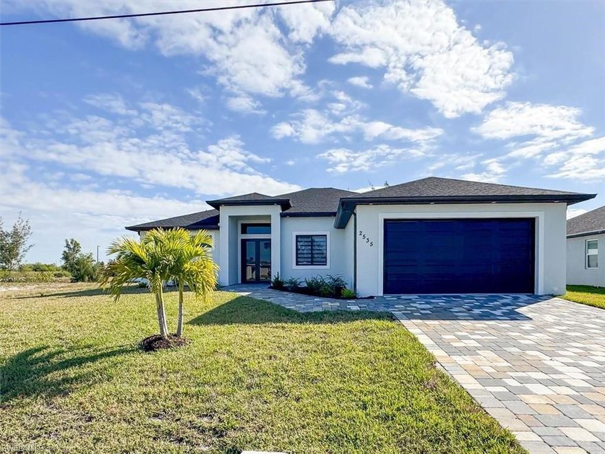 City Water & Sewer in and paid in Full, not in a flood zone, no flood insurance required. 
Welcome to this stunning new-construction waterfront retreat in beautiful of SW Cape Coral, set along a peaceful freshwater canal with no flood insurance required, this custom 4-bedroom, 3-bath, 2-car garage pool home offers 2,009 sq ft of beautifully designed living space with serene water views and exceptional craftsmanship throughout.

Step inside to a bright, open great-room layout highlighted by soaring 12’ tray ceilings, 8-foot doors, and a triple-slider that fills the home with natural light and creates seamless indoor-outdoor living. The gourmet island kitchen is a chef’s dream, featuring white Shaker all-wood soft-close cabinetry, white quartz countertops, glass tile backsplash and island accent, upgraded stainless-steel appliances, pendant lighting, and a large walk-in pantry—perfect for entertaining and everyday convenience.

This thoughtfully designed home main suite is a private sanctuary with space for a king-size bed and seating area, direct lanai and pool access, and a spa-inspired ensuite showcasing a walk-in shower, frameless glass enclosure, and custom closet cabinetry.

Large-format tile flooring flows throughout the home, complemented by 5¼" baseboards, custom bath selections, and a complete light and ceiling-fan package. Impact-rated windows, doors, and sliders provide storm protection, energy efficiency, and lower insurance costs while allowing abundant natural light.

Step outside to enjoy true Florida living with a pool, paver driveway and pool deck, outdoor kitchen, and a fully landscaped yard with sprinkler system and Floratam sod, all overlooking tranquil canal views—perfect for kayaking, fishing, or relaxing by the water.

Additional highlights include city water and sewer installed and paid in full, soffit lighting, and construction by a trusted local builder offering exceptional quality and value.

This is a rare opportunity to own a luxury canal-front new-construction home in SW Cape Coral that delivers on design, lifestyle, and long-term investment appeal.