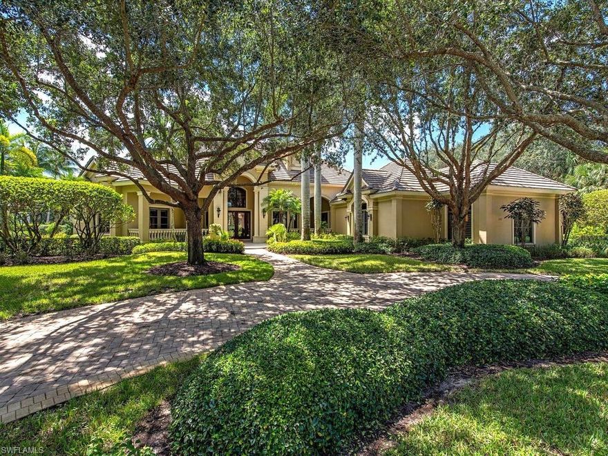 A truly refined estate, built by McGarvey Homes. Highlights of the home include marble & wood floors, an expansive outdoor kitchen & entertainment space with a pool & spillover spa. Picturesque landscaping creates enticing curb appeal that welcomes you into this home. Notable features include subtle wood accent ceilings & cabinetry adorning the gourmet kitchen with built-in appliances, a large center island & breakfast bar. Enjoy curated selections from the wet bar while hosting guests in the formal dining room. Wood floors & intricate coffer ceilings add warmth to the sunlit home office with built-in shelving. Rest & relaxation abound in the serene primary suite with a private sitting area & stacking slider door that opens directly to the sparkling pool and screened lanai. The primary bath inspires tranquility with marble floors, wood vanities, a spacious soaking tub & walk-through shower. A private cabana bedroom with full bath is just beside the well-equipped outdoor kitchen. Covered seating & dining areas allow year-round enjoyment of the beautiful Naples weather, overlooking a peaceful lake with immaculate, lush landscaping. The lagoon-shaped pool & spillover spa is the ideal place to relax & soak up the Florida sun.  ROOF-A-CIDE CONTRACTS AND A/C SERVICE CONTRACTS ARE UP TO DATE AND ARE TRANSFERABLE.