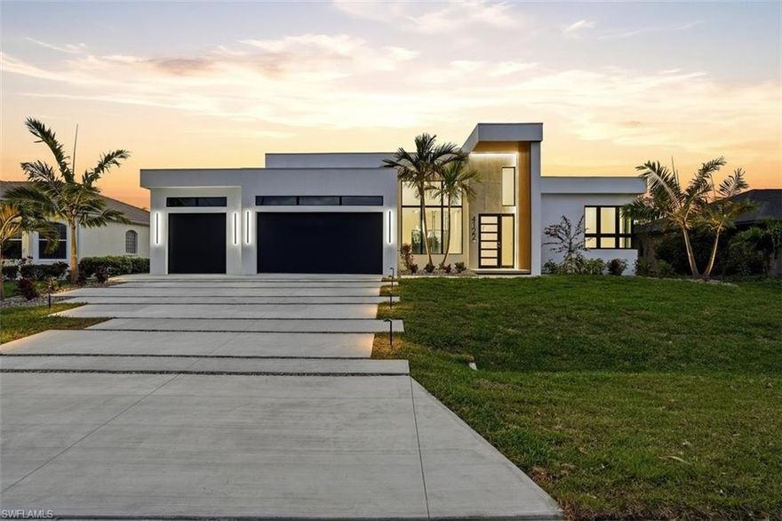 Welcome to 4122 SW 27th Place, an exceptional ultra modern waterfront residence that blends striking contemporary architecture with refined coastal living. Positioned on a 100 foot wide canal with desirable western exposure, this custom home offers beautiful sunset views and a peaceful waterfront setting in one of Southwest Cape Coral’s most quiet and desirable neighborhoods.
The home immediately impresses with its bold architectural presence, featuring a dramatic modern facade, flat roof design, expansive glass, and a grand two story entry that fills the interior with natural light. Inside, the open concept layout showcases impressive ceiling heights ranging from 14 to 16 feet in the main living areas, creating a bright and airy atmosphere designed for both comfort and entertaining.
At the heart of the home is a beautifully designed chef’s kitchen anchored by a large statement island with waterfall edges, custom cabinetry, and high end finishes. The space flows seamlessly into the dining and living areas, where a striking custom entertainment wall with polished concrete finishes, built in cabinetry, and integrated design elements creates a dramatic focal point. Just off the main living space, a stunning glass wine display with an adjacent beverage bar adds a sophisticated architectural feature perfect for hosting and entertaining.
The residence offers four spacious bedrooms and three full bathrooms. The primary suite is designed as a private retreat, featuring serene views, a generous walk in closet, and a spa inspired bathroom complete with a freestanding soaking tub, oversized glass shower, and elegant modern finishes.
One of the home’s most impressive elements is its seamless indoor/outdoor living experience. Large sliding glass doors open to an expansive covered lanai, creating a natural extension of the interior living space. The outdoor area features a resort style pool and spa, a fully equipped outdoor kitchen, and a dramatic linear fireplace feature wall that adds warmth and ambiance to the lanai while overlooking the tranquil canal.
The property sits on a 100 foot wide canal with one bridge and approximately 45 minutes to open water, offering enjoyable boating access while maintaining a calm and protected waterfront environment. The backyard currently provides a clean waterfront canvas, allowing future owners the opportunity to design and build a custom dock tailored to their boating lifestyle.
Additional highlights include hurricane impact insulated windows and doors, extensive LED lighting throughout the home, modern architectural finishes, and thoughtful design details that enhance both comfort and visual appeal.
Situated on a quiet street that ends in a cul-de-sac with only a few neighboring homes, the property offers privacy and minimal traffic while remaining conveniently positioned near shopping, dining, marinas, and entertainment throughout Cape Coral.
