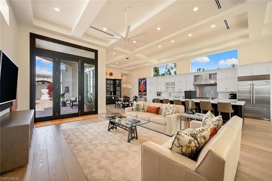 Welcome inside this one-of-a-kind 3,800 square foot Villa home that defines a new age of redevelopment for Pelican Bay's desired Grand Bay gated community and experience its luxury debut. Masterfully re-imagined by Fleming Architects and Glendale Group Builders, this luxurious home was expanded and rebuilt with refined modernity, unrestrained beauty and superior craftmanship. Enter the voluminous great room flanked by stunning 14-foot coffered ceilings and walls of glass that stream natural light throughout the day. Multiple living and dining areas are designed for ease and open flow of entertaining and modern living. The centerpiece gourmet kitchen is a chef’s dream with premium appliances and an expansive center island. A separate wine tasting and beverage bar holds 200 bottles of your finest. This impeccable residence boasts four bedrooms with four en-suite baths plus a powder room. Guests will feel especially welcome in the private Cabana bedroom suite and bath. Fine custom cabinetry and architectural millwork throughout the home ensure timeless and enduring design. New roof, impact windows and doors, electrical and plumbing, appliances, mechanicals and the finest of luxury hardwood and stone finishes dovetail with exceptional design to provide the ultimate living experience. Ideally near tram station for access to Pelican Bay’s world-class beach amenities. Superior elevation with no effect from Ian, according to the owner. This exceptionally grand villa awaits its illustrious owner.