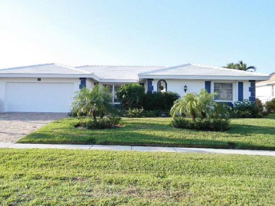 Beautifully-updated waterfront home in the desirable Tigertail Beach area of Marco Island. This warm & inviting home has a generous floor plan that feels larger than the stated size. Updates include new HVAC in 2010, kitchen & master bath remodeling in 2015, new custom front door in 2015, metal electric roll-down shutters on Lanai in 2016 and new roof in 2017. Kitchen renovation includes custom maple cabinets (designed with built-in china cabinets with glass fronts & all cabinets built to the ceiling for added storage), quartz countertops, stainless appliances and floor resurfacing. Master bathroom updates include new cabinets, Carrara marble vanity & frameless shower door. Terrazzo floors throughout. Home was painted inside and out in 2015. Water heater replaced in 2016. New generator installed in 2016. Exterior features include freshly stained boat dock, lush landscaping & a large back yard with plenty of space to design and build your own pool & tropical oasis. This home has a great location that is less than a quarter mile to Tigertail Beach with southwest rear exposure for lots of sun all year. This home is the perfect place to enjoy the Marco Island lifestyle.