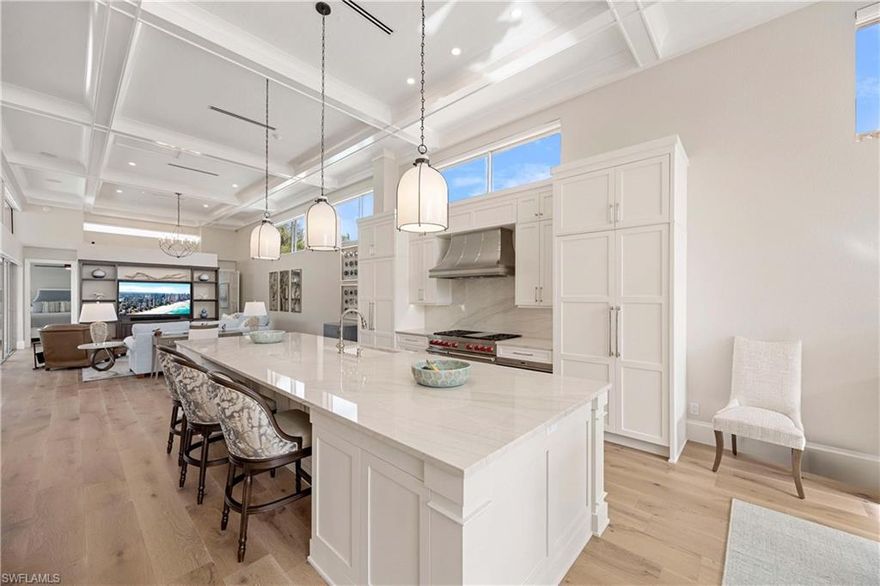 This extraordinary, completely remodeled Aruba Model Villa has been reimagined into a timeless coastal masterpiece situated with some of the most sought after golf course views Naples has to offer. Every detail has been transformed, blending sophisticated elegance with unparalleled craftsmanship and luxury. The result is a one-of-a-kind home that is truly breathtaking.
Upon entering, you are greeted by stunning high end hardwood floors and walls in warm, inviting tones. Soaring ceilings with dramatic beams create an expansive, open atmosphere throughout this luminous, airy home. Custom chandeliers add a touch of glamour, while the thoughtfully designed ensuite bathrooms feature exquisite counters and high-end plumbing fixtures.
The chef’s gourmet kitchen is a culinary dream, with custom white shaker-style cabinetry, designer appliances, and a premium gas stove—ideal for preparing meals in style. The outdoor covered courtyard is equally impressive.
Uniquely positioned on the Pelican Bay Golf Course, this rare villa offers a southern exposure with unmatched privacy, thanks to its lush bougainvillea-covered trellises and beautifully landscaped patios. From the serene backyard, enjoy sweeping views of the golf course and serene lake beyond—just a short iron shot from the green. .
This exceptional residence presents a once-in-a-lifetime opportunity to own one of the most coveted villas in Naples, offering unmatched luxury, beauty, and privacy in a truly enviable location.