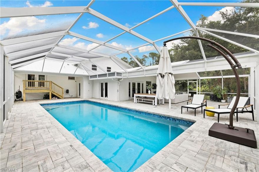 PRICED TO SELL. PRIME LOCATION - WEST OF I-75. Discover a rare opportunity to own 1.14 acres just 10 minutes from downtown Naples and the beaches - an expansive, beautiful fully renovated retreat (2025-2026) in the desirable X-Flood Zone with no HOA and plenty of room for your boat or RV. Offering 4 bedrooms including a private guest space / bonus room ideal for in laws or home office, this 3,426 sq. ft. home balances modern luxury with the kind of space and privacy that are almost impossible to find so close to town. Step inside and feel the calm of a home transformed with quality care. A new white metal roof and all-new impact windows and doors provide peace of mind. The designer kitchen anchors the home with Café appliances, striking Black Panther quartzite countertops and backsplash, and a spacious island perfect for gathering and entertaining. The primary suite offers a true retreat with a fully reimagined, spa-inspired bath, offering a spa-like escape at the end of the day. Throughout the home, new upscale lighting, flooring, fans, baseboards, and trim add warm sophistication, while two new Carrier HVAC systems ensure year-round comfort. Major infrastructure improvements provide lasting peace of mind, including a new septic tank, drainfield and whole home reverse osmosis system. Outside, the lifestyle expands even further with an almost 2500 sq. ft. resort style screened pool enclosure, an oversized pool with new pool heater, and a fully fenced backyard that feels quiet, serene, and full of potential. Whether you envision creating a garden, adding a guest structure, or simply enjoying wide-open space, the possibilities are endless. This is more than a move-in-ready home. It’s a peaceful Naples sanctuary where you can spread out, unwind, and truly live, all within proximity to everything Naples has to offer. Acreage properties this close to beaches and downtown Naples rarely come to market.