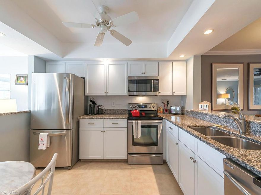 C.15816 - A Rare Opportunity in the 27-Hole Championship Bundled Golf Community Fox Club! Enjoy this recently updated and well-maintained 3 bedroom, 2 bath, carport ground floor end-unit condo. Enter your new home through the formal living and dining area, open kitchen with 2 breakfast bars, which also opens to a separate family room. The family room offers a 180 degree panoramic view over the community golf course & lake with. Create homemade meals in the newly appointed kitchen, offering 30" solid oak cabinets with granite counter tops & stainless steel appliances, Enjoy in the newly updated bathrooms with glass enclosed showers, custom mirrors and 30" solid oak cabinets. Hassle free 18" floor tiles throughout the home, lush carpeted bedrooms, 12" floor tiled lanai. Master bedroom offers walk-in closet. Other updates include newer HVAC System (March 2015). Start enjoying all SW Florida has to offer! Only minutes to Olde Naples Beaches, Boutiques & Restaurants, & I-75.