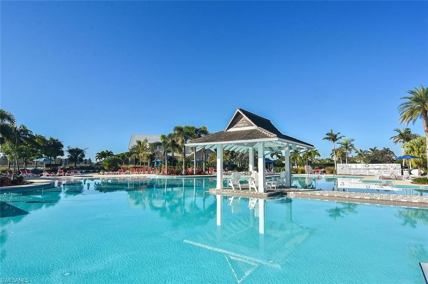 Luxury Florida Lifestyle! Madison II, a Stock Development home. Fully furnished, 4 bd + den, 4 full bath, 1 half bath, 3 Car Attached Garage, beautiful resort style heated saltwater pool & spa with massive water views. 3054 sq. ft under air, a total of 4779 sq. ft. Walls of pocketing and zero/corner entry glass sliding doors provide great indoor/outdoor entertainment including your complete outdoor kitchen. Open floor plan, formal dining, chief’s kitchen with gas cooktop, high-end appliances, and an oversized island. Features: impact windows and doors, plantation shutters throughout, quartz countertops, volume ceilings, custom closets in master, new custom-built cabinets, hurricane screens on the lanai, a full house generator, 500-gallon propane tank, a plug-in  for EV, new custom cabinets installed in the garage. Community offers resort style amenities. Enjoy cocktails and delicious food in the community Key West style restaurant. There are over 8 miles of scenic hiking/biking trails, kayak (gulf access) fitness center, classes, sauna, locker room, pickleball, tennis, bocce, resort pool & lap pool and special events on the lawn. Just minutes to downtown Naples 5th Ave restaurants