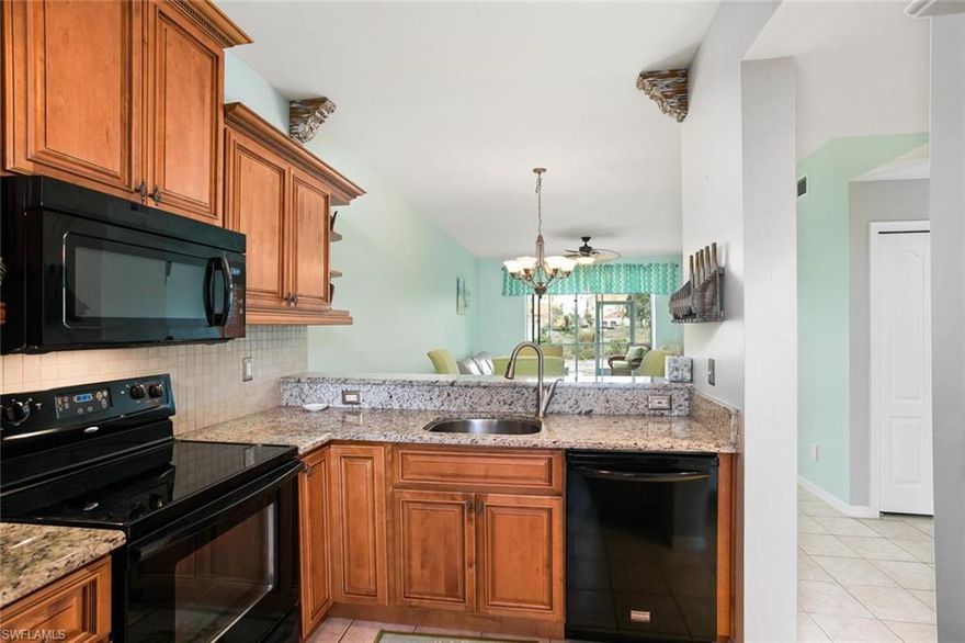 Nicely updated kitchen with granite counter-tops & wood cabinetry. First floor condo overlooking the golf course with an open floor plan, split bedrooms, screened entry & covered parking.  Electric hurricane shutters on the screened porch.  Substantial reserve fund; new roofs in 2018.