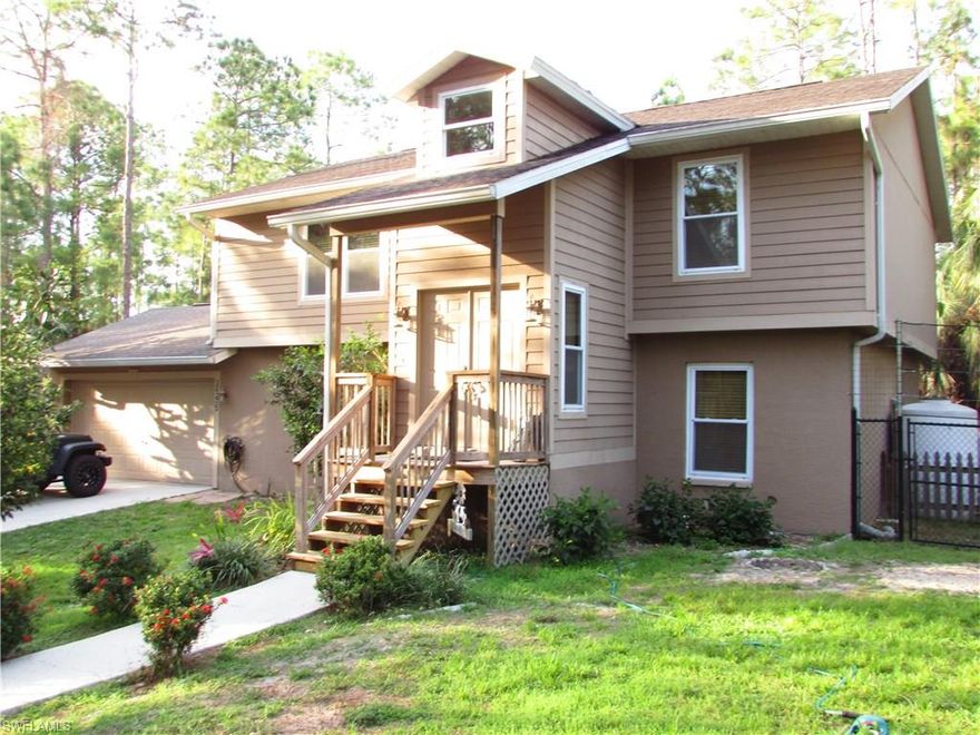 Home Warranty Included!! Beautiful & secluded 3 bedroom + Den/2 Bath Pool home in the Estates, close to Golden Gate Blvd. 2 story, Split bedroom floor plan with master bed/bath on top floor. This is a very well kept home. Large elevated porch to enjoy the peaceful wooded surroundings. The large pool in surrounded by a screened lanai.  The asphalt paved driveway leads up to 2 car attached garage.  This home features an RO water system with 500 gal storage capacity and the ability to generate 3200 gal/day.  The home is equipped with a split AC system 19 SEER upstairs, 17 SEER downstairs. Stainless steel kitchen appliances, front loading washer/dryer, impact resistant glass windows and a WiFi enable programmable thermostat.  Perimeter fencing surrounds portion of property.