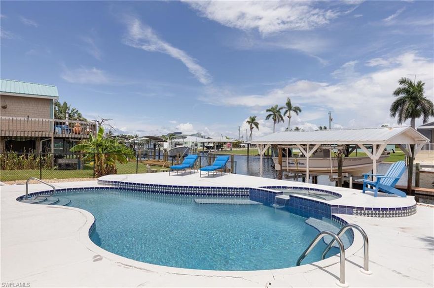 Waterfront luxury, move-in ready — and just minutes to the Gulf! New pool liner to be installed December 2025! This updated 3-bedroom, 2-bath Saint James City home offers a heated pool & spa, deep-water canal with sailboat access, and a 10,000-lb lift (boat on lift is negotiable). Nearly everything is new, from the roof to the kitchen — all that’s missing is you. Welcome to your waterfront paradise on one of the most desirable canals in the quiet, friendly neighborhood of Saint James City. There is no HOA or CDD with this three bedroom, two bath home and property. The home has been beautifully updated and showcases elegant tile flooring throughout, offering great style and easy maintenance. The new stone countertops and cabinets are timeless, boast elegance, and maintain durability. The heart of the home features stainless steel kitchen appliances and new washer and dryer. The roof, water heater, and raised A/C were new in 2022. Almost everything about this home has been fully updated! Step outside from the living room or from two of the bedrooms to the large oasis, complete with a sparkling deep heated pool and a newly renovated spa that flows into the pool – ideal for private relaxation and rejuvenation. A portion of the lanai is covered and ideal for outdoor seating and dining; the larger poolside area provides great space to lounge in the sun and take in the views of the canal, sunrises, and sunsets. Boating enthusiasts will love the 10,000 lb boat lift and the wrap around dock. The deep water canal provides direct sailboat access and is ideal for every boating, kayaking and fishing interest. Pine Island Sound and the Gulf itself are mere minutes away, providing memorable trips to Sanibel, uncrowded beaches, and sunset cruises so close to home. Fish in the Tarpon Capitol of the world, and catch Redfish, snook, and Seatrout along the mangroves of Pine Island Sound. Watch dolphins play and manatees lounge right under your dock! Enjoy quaint shops, nearby grocers, and excellent waterfront dining with fresh faire, delicious refreshments, and live entertainment. Soak in the historic culture of Pine Island and its nature preserves. This is known as “Old Florida” so serene and quiet, yet so conveniently located to airports, golf courses, and all that Ft. Myers and Cape Coral offer within a short drive. This property is a fantastic home and an incredible investment opportunity at a great price. Don’t miss out on this rare gem – schedule your private tour today and consider living the Southwest Florida dream!