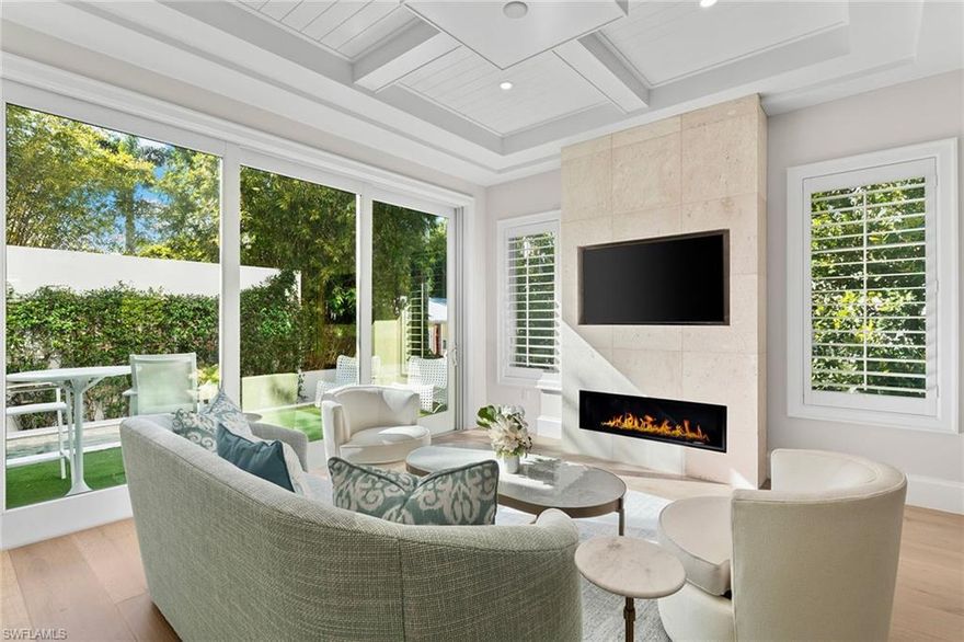 Newly completed in 2024 and never lived in, this distinguished two-story pool residence embodies the timeless charm of cottage living in the heart of Olde Naples. Thoughtfully designed with 1,976 square feet under air, the home blends classic coastal architecture with elevated modern comforts. The gracious floor plan offers a spacious first-floor primary suite, providing a private sanctuary with a spa-inspired bath, walk-in closet, elegant finishes, and serene proportions. Throughout the home, warm-toned wide-plank wood flooring creates continuity and warmth, bespoke detailing, plantation shutters and a curated selection of luxury appliances. The gourmet kitchen includes custom cabinetry, a beautiful wrap-around backsplash, quartz counter tops, soft brass finishes, and a convenient center island with a 2-drawer refrigerator and freezer. Designed for both formal and relaxed entertaining, the open great room with floor to ceiling tiled linear gas fireplace and TV shelf flows seamlessly into a beautiful a dedicated dining area, both overlooking the inviting and outdoor deck and pool—an ideal setting for intimate gatherings, morning coffee or quiet afternoons. The second level reveals a refined open loft, perfect for a sitting room or reading retreat, along with two generously sized en-suite guest bedrooms and a generous and thoughtfully designed laundry room. Clive Daniel Homes furnished the home and it is being sold with furnishings. Perfectly positioned within walking distance to Fifth Avenue South and just minutes from the Gulf beaches, this exceptional residence places you in the heart of downtown Naples, surrounded by fine dining, boutique shopping, galleries, and theatres—capturing the true spirit and enduring coastal elegance and vibe of Olde Naples.