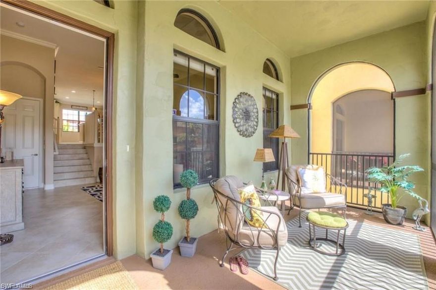 Light-filled, immaculate townhome, desirable quad unit with pool. AC unit less than three years old! Full-width, screened-in lanai welcomes you to this highly-upgraded home.  Open layout split-level main floor with ample natural light. Spacious living room on lower level, combined dining/kitchen upper. Gourmet kitchen features custom cabinetry, granite counters, stainless appliances, pantry, powder room, upgraded lighting, and a large window overlooking the quad pool. Hardwood floors on 2nd floor. The owner's suite offers two walk-in closets with custom shelving, and a full bathroom. The guest bedroom also features its own full bath. Plantation shutters, crown molding, and neutral colors throughout. Move-in ready! This won't last!