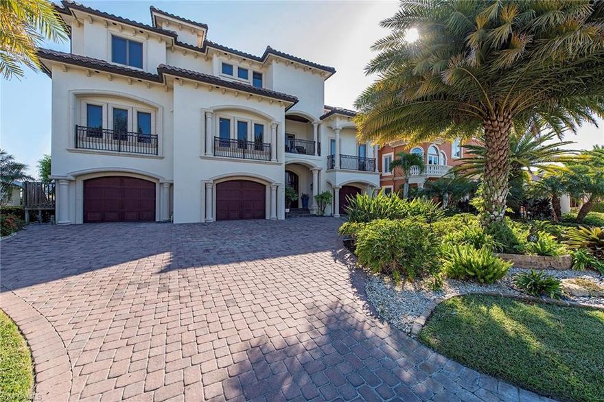 This is a true waterfront gem in one of the most desirable locations on Vanderbilt Beach. Enjoy this elegant, five-bedroom estate home with spectacular bay views, located moments away from our beautiful sandy beaches and the popular La Playa resort. This luxurious and architecturally detailed residence boasts quality workmanship covering 5,860 square feet of living space. An inviting large and open great room, a chef's gourmet kitchen with premium quality Wolf appliances, beautiful mahogany hardwood and decorative marble floors are just a few of the features of this magnificent home. Once outside, you will love the sparkling infinity edge pool and spa surrounded by a large covered lanai with an outdoor kitchen and fireplace. This home truly has it all! Make your dream of a beach and boating lifestyle a reality in this elegant yet easy living home.