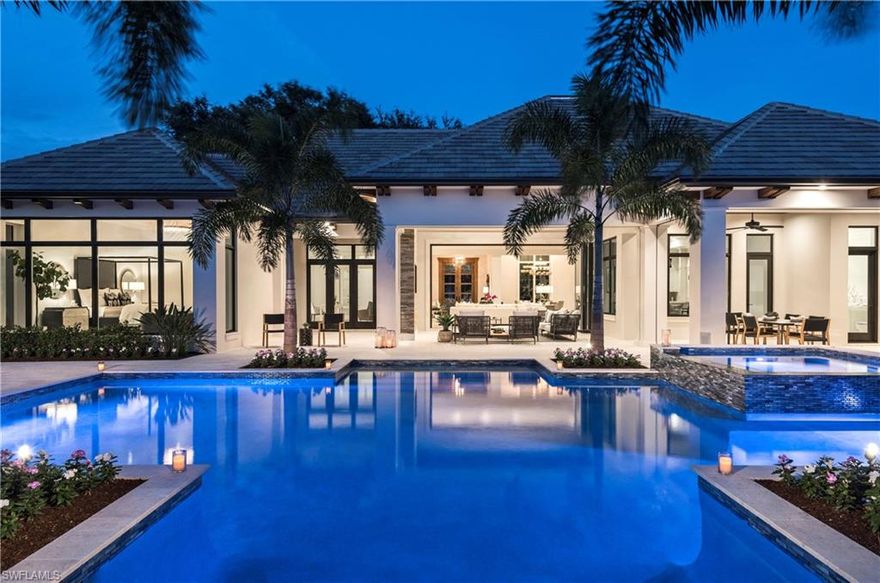 Construction is complete! With beautiful views in every direction, this 5100 sf rustic contemporary lakefront estate home in the heart of Pelican Bay features a classic contemporary open concept interior. A 20’ floor to ceiling folding glass wall seamlessly integrates amazing indoor and outdoor living spaces. Unique custom built-ins compliment the fashionable interior, which also features wide plank Italian oak floors, floor-to-ceiling windows, hand-crafted millwork, soaring ceilings, and stunning finishes. Natural light fills the spacious master suite, featuring separate baths/dressing room/closets. Fabulous kitchen design includes top-of-the-line Wolf/Subzero/Bosch appliances, custom cabinetry, and 2" quartzite counters throughout. The club room overlooks a stunning outdoor great room and dining area with remote controlled roll down screens/shutters, TV, fireplace, summer kitchen + bar overlooks the 50' lap pool and 8' infinity spa. 4 ensuite BR, 5 full/2 half baths, 3 garages. Remote control smart technology, lighting control and pre-wire for AV and sound systems included. No detail was overlooked in this SW exposure lakefront dream home.