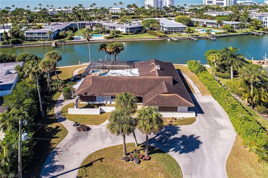 A beautiful homesite tucked away at the southern end of Coquina Sands with approximately 155 feet on the calm waters of Hurricane Harbor. Great location, close to the beaches of Lowdermilk Park and just minutes to the shopping and dining of Old Naples. Western sunset views and lovely long water looks to the north towards Mooring Line bridge. The large home has potential for the right buyer but is offered as-is for those longing for the perfect site to create their own vision. Please do not walk the property.
