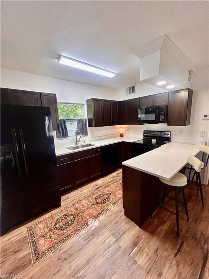 Discover this charming and unique BEN MAR CONDOMUINUIMS located in the highly desirable DEAN PARK HISTORIC DISTRICT, One of Downtown Fort Myers most treasured neighborhoods. This newly renovated, PARTIALLY FURNISHED 1 Bedroom/1 Bath condo features new hurricane windows, all new appliances, granite countertops, life proof luminant flooring, as well as a new AC. The condo is perfectly situated on First St. and is a 10 min walk into the downtown Fort Myers, just across from the Caloosahatchee River, the location is considered in the heart of The Historic Downtown Fort Myers River District. Downtown Fort Myers features high-end dining, art galleries, bars, boutique shopping and vibrant nightlife.  The River District offers the perfect blend of culture, entertainment and charm right outside your door. Residents enjoy the convenience of the trolley stop right in front of the community, making it easy to explore all that Downtown has to offer. The Ben-Mar Condominiums provide a private setting as well as a beautiful courtyard swimming pool for relaxation and a community laundry facility for everyday convenience. This property offers the rare combination of historic charm, a walkable urban lifestyle, and secure community living — making it an excellent choice as a primary residence, seasonal retreat, or investment opportunity. Don't miss this affordable opportunity to live, work or invest in the growing vibrant downtown Fort Myers. Low condo fees, water included, making this property even more appealing and desirable.