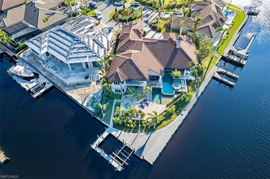 This Wyman Stokes "Retreat" model home is located in The Estates of Cape Harbour, one of the most sought-after waterfront communities. It offers a view of the intersecting deep water South Spreader Waterway and the Dap Canal with perfect boating access for up to a 100' yacht. This furnished, professionally decorated residence offers unparalleled perfection and execution including an oversized master bedroom with an en-suite bath, four additional bedrooms all with en-suite baths, a custom chef's kitchen with top-of-the-line appliances, and a center island. The private heated tiered saltwater pool with spa, summer kitchen, and covered loggia for dining al fresco are some of the other features of this amazing home. The residence is situated perfectly on a cul-de-sac among other custom Estate homes and offers 5344 living sq ft and over 7600 total sq ft. There are 2 fireplaces one in the formal living room and one in the secluded courtyard... great for entertaining or just relaxing. The second-floor wing features an en-suite bedroom which is currently being used as an office, a large game room with a full bar, and access to the large tiled balcony overlooking long water views. There is approximately 220' of frontage on the water and includes composite decking, Captain's Walk, and a lift with a worm driver lift system. This unique home is just waiting for that special owner who wants nothing but the best.
