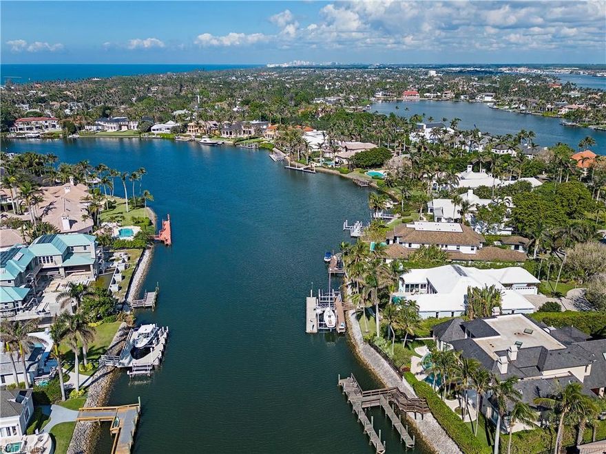 Boaters paradise! Short walk to the beach. Enjoy outstanding panoramic wide water views with 116 ft. of water frontage. Western exposure provides beautiful sunsets over Morgan’s Cove. This well maintained property is perfect for entertaining with an open floor plan encompassing multiple living areas that flow seamlessly from the indoor space  to the expansive outdoor living areas including lanai with a retractable screen and gorgeous resort style pool and spa. This desirable property is finished with a newer dock with boat lift, fish cleaning table, a concrete 60 ft. floating dock with 2 lifts-a 13,000 lb boat lift and 10,000 lb. The updated chef’s kitchen showcases granite counters, custom cabinetry, Wolf 6-burner gas range, Wolf double oven, stainless steel Bosch dishwasher, quadruplet wine cooler, and wet bar. Home is finished with automatic hurricane shutters and an air- conditioned 3-car garage. Ideally located in prestigious Port Royal in just minutes from 3rd Street South’s and 5th Avenue South's fine dining, world-class shopping and white-sand beaches. Port Royal Club Eligibility.