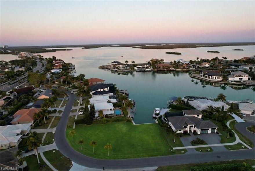 This is a rare chance to secure an oversized corner waterfront lot at the meeting point of wide, converging waterways, offering long, open water views and an incredible setting for a custom home. The property spans approximately 0.38 acres and already features a brand new seawall completed in 2023, saving both time and significant upfront expense when it comes time to build. From your future dock, you will have quick, deep water access to the Big Marco River and direct access out to the Gulf of Mexico, making it ideal for boating, fishing, and exploring the surrounding 10,000 islands.

The size and corner positioning of the lot give you the flexibility to design a substantial one or two story home with expansive outdoor living, a large pool, and multiple garage bays. There is plenty of room to create a true waterfront estate that takes full advantage of the views and the Marco Island lifestyle. The converging water views add a sense of openness and privacy that is difficult to find, and they will serve as a focal point from nearly every main living space. Wide water exposure also allows for larger dock configurations, making it easier to accommodate multiple vessels, lifts, or a larger boat.

Surrounded by newer luxury homes and ongoing custom construction, this is a neighborhood where builders and end users continue to invest. Many nearby properties have been redeveloped into high end residences, reinforcing the long term value and appeal of the area. The street itself is quiet and residential, yet centrally located, allowing you to be anywhere on the island within minutes. The location is convenient to everything Marco Island has to offer, including white sand beaches, marinas, waterfront restaurants, shopping, parks, and schools, while still maintaining a peaceful waterfront setting.

This property is especially appealing for those who want to build without unnecessary delays. The new seawall provides a major head start, and the lot dimensions allow for creative architectural design, whether your vision includes a modern coastal home with floor to ceiling glass, expansive lanais, and outdoor entertaining areas, or a more traditional island style residence. The corner orientation also improves curb appeal and offers more flexibility with driveway placement, garage access, and overall site planning.

Oversized waterfront lots with converging water views, new seawalls, and quick Gulf access are becoming increasingly difficult to find, particularly in established Marco Island neighborhoods. Whether you are building a personal residence, a seasonal retreat, or a spec home, this is a strong opportunity to secure a premium homesite in one of the island’s most desirable boating locations.
