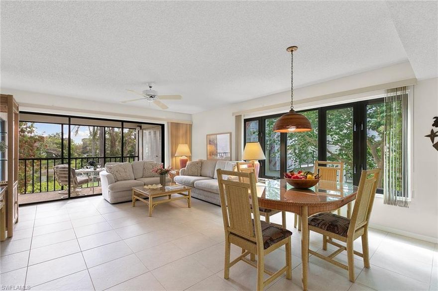 Enjoy beautiful sunrises sipping your morning coffee from the screened lanai of this second floor condominium. Just a few steps from the community pool, this end-unit home with an abundance of south-facing windows lives peacefully among the trees. Inside, the comfortable furnishings, open floor plan, stocked kitchen cabinets and ample closets of this lightly lived in home provide the perfect solution to your Naples search. The large primary bedroom with walk-in closet offers plenty of light as it opens to the lanai. Two bedrooms/two baths. Impact windows were installed in 2020 in the primary bedroom and living/dining rooms. The west-facing, large front porch with extra storage closet and private screened back lanai, with washer and dryer in closet, offer lush views as you enjoy your tropical lifestyle in this turnkey-furnished home. Located minutes from shopping, entertainment, dining and 4 miles to the sugar white sands of the Gulf beaches, Naples Bath and Tennis is truly in the heart of Naples. This naturalistic community offers serene options for biking, jogging, dog walking, etc. No rentals until after three years of ownership on Oyster Catcher Point.